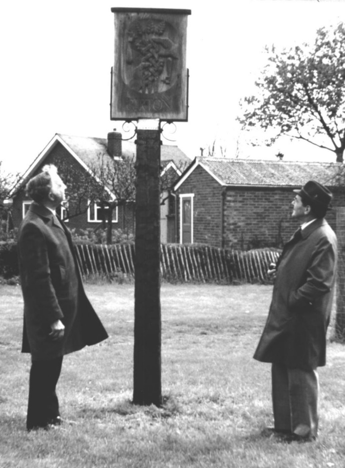 Jack Burton left and Claude Farey right opening the village sign which was carved by Shelley faussett