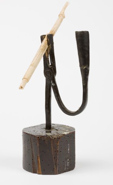 A rush light.The pith of the soft rush was dipped in melted wax or tallow and used for wicks in rush light. This was the cheapest form of lighting as candles were expensive.
