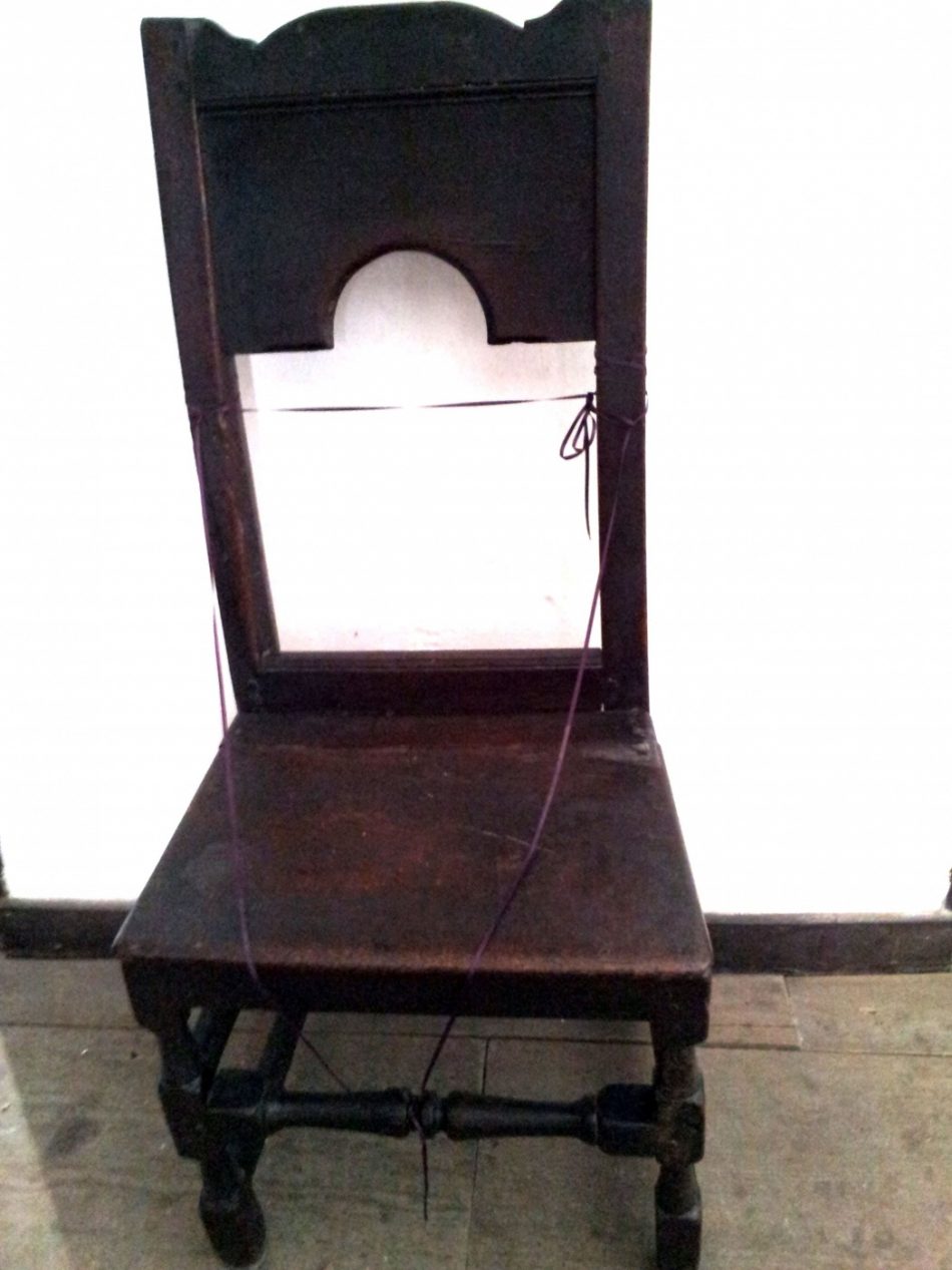 A plain wooden chair with no arms, known as a back chair or chair stool.
