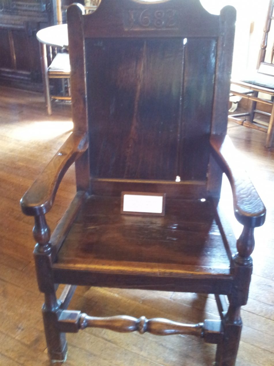 A plain chair with arms.
