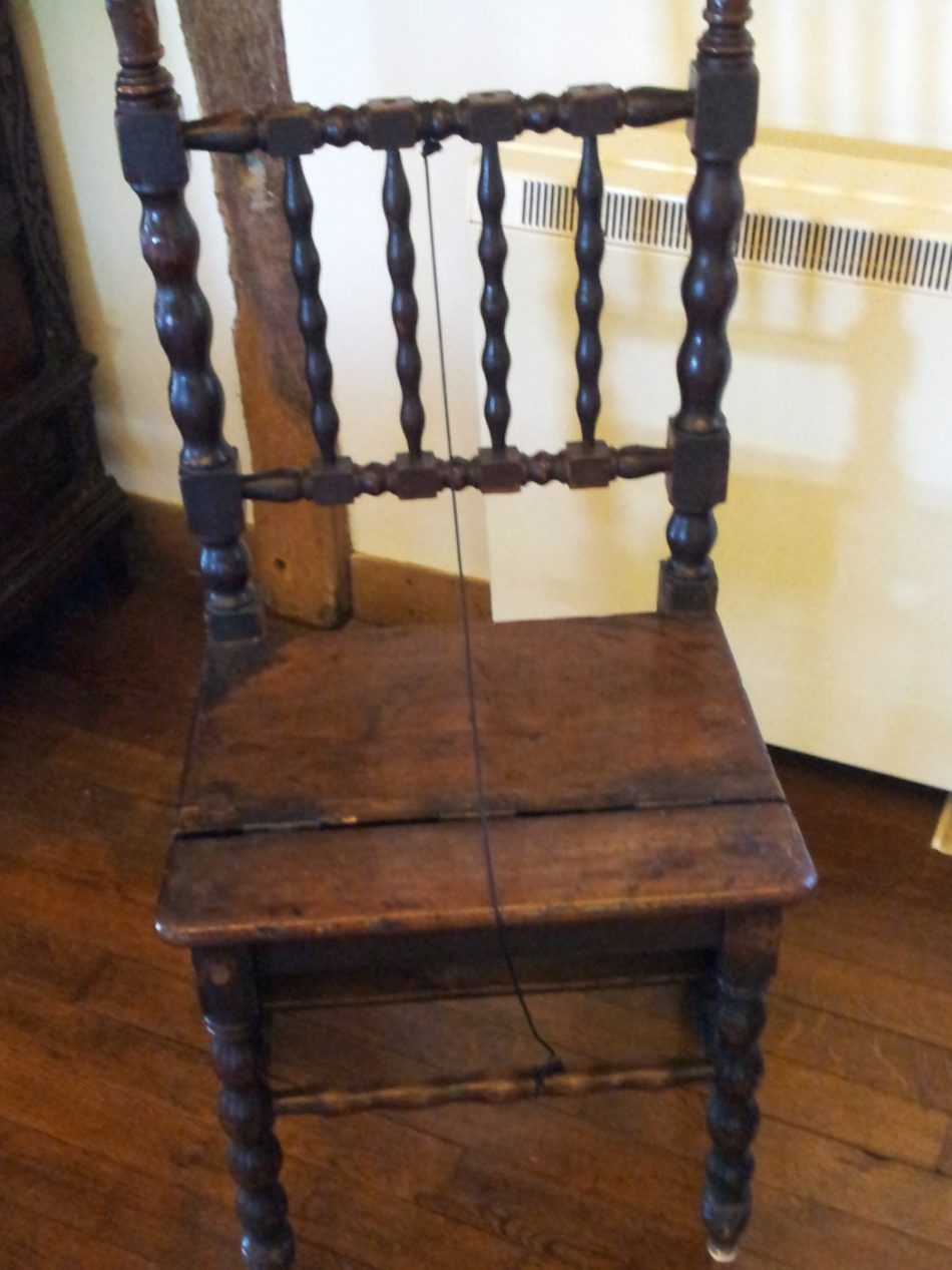 A chair with a turned balusters between the frame.
