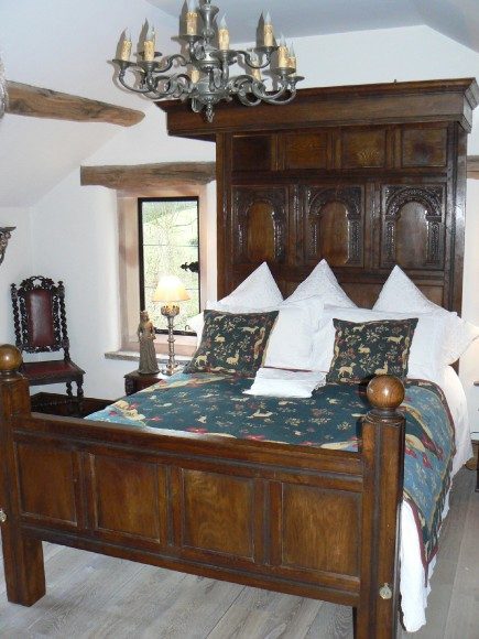 A half headed bed with canopy covering only the top half of bed.
