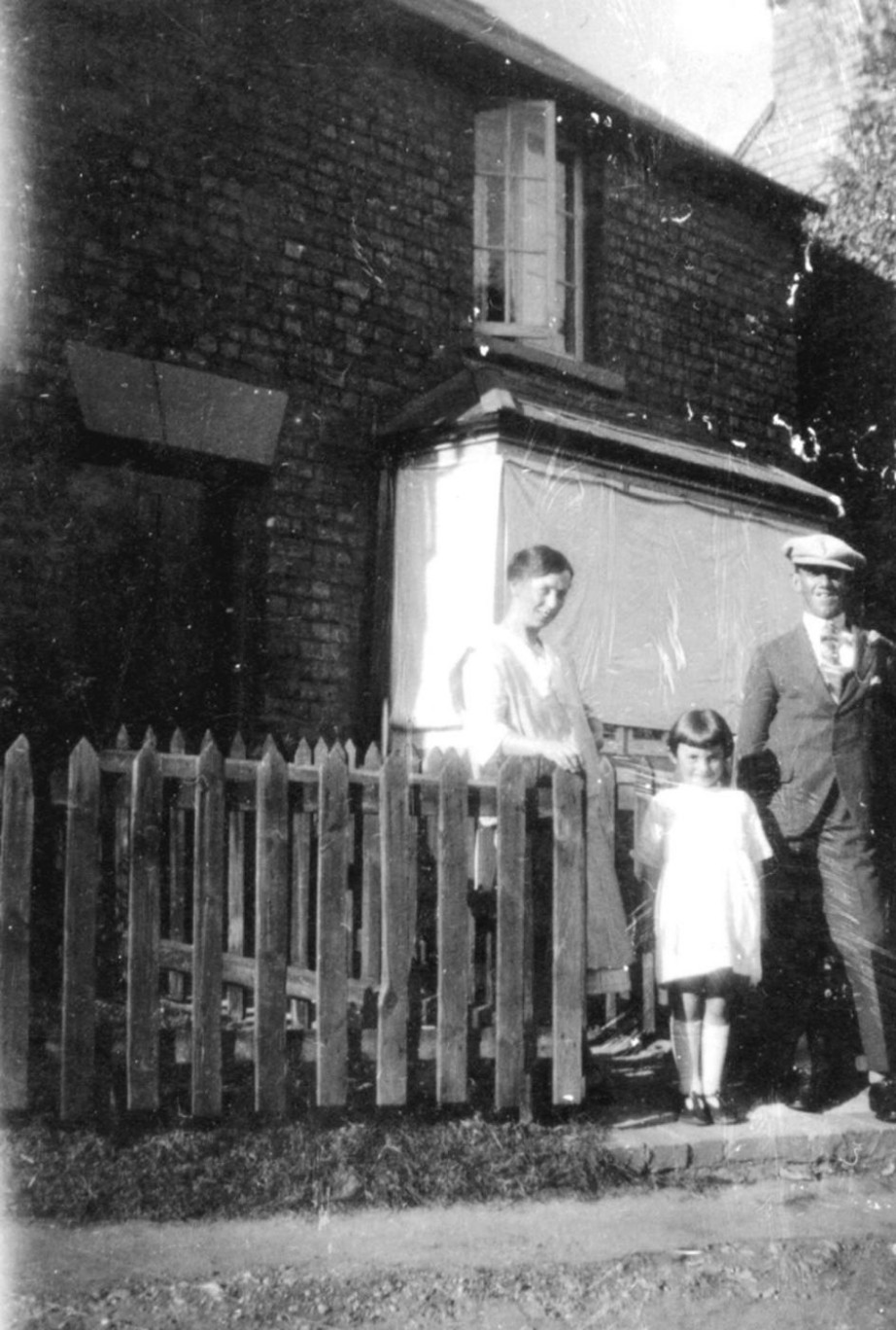 Ruth and Ted Titmuss with the their daughter Vera outside the hardware shop in the late 1920s